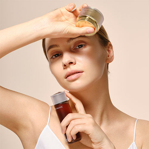 model holding skincare